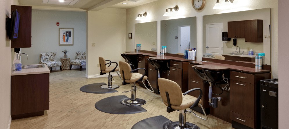 A modern salon interior featuring styling chairs and mirrors.