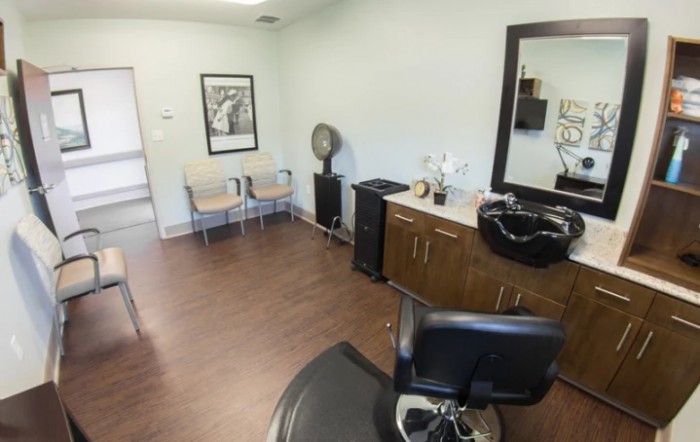 A cozy hair salon interior with a styling area and waiting space.