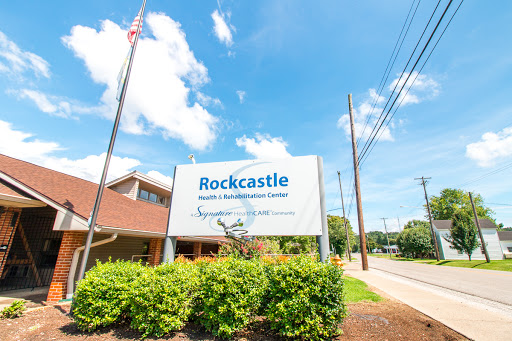 Rockcastle Health Center sign featuring clear skies and lush greenery.