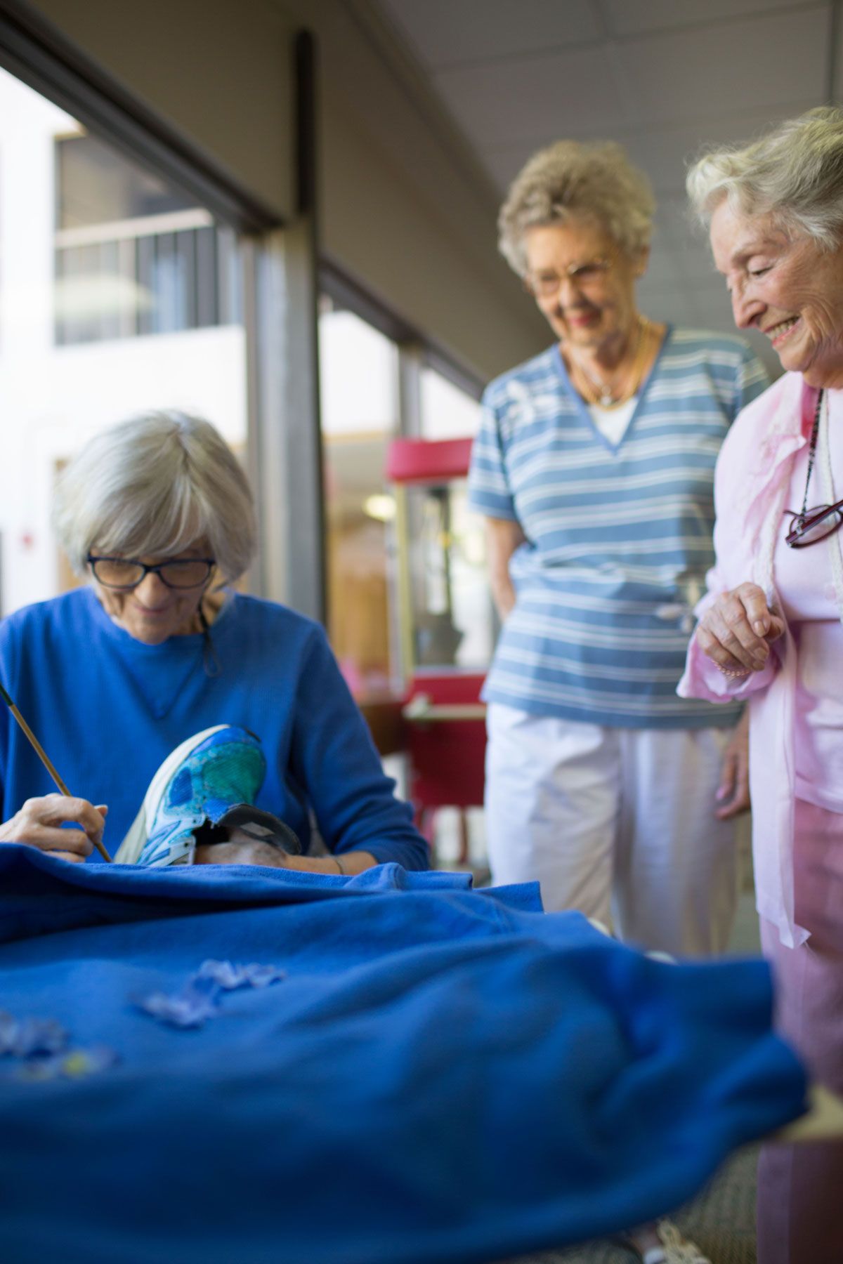 A group of senior women enjoying a knitting activity together.