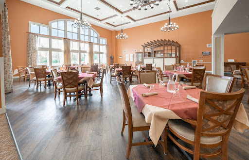 A beautifully arranged dining area in a restaurant, featuring elegant tables and warm decor.