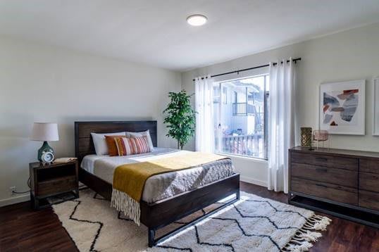 A modern and cozy bedroom with stylish decor and ample natural light.