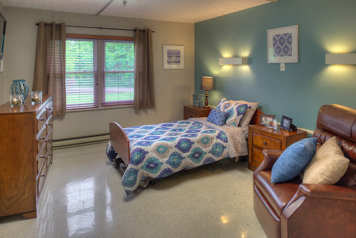 A cozy and well-lit bedroom featuring a comfortable bed, stylish decor, and natural light from the windows.