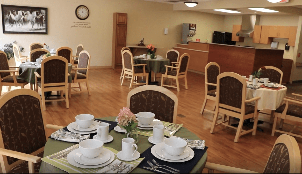 A dining room with neatly set tables and chairs, ready for guests.