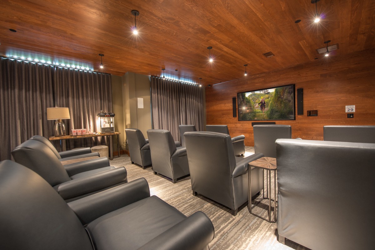 A modern home theater with comfortable seating and a large screen.