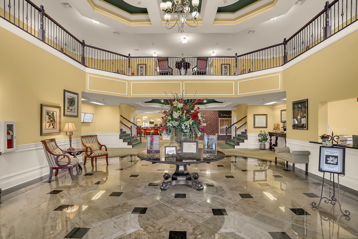 A luxurious hotel lobby with elegant furnishings and a grand staircase.