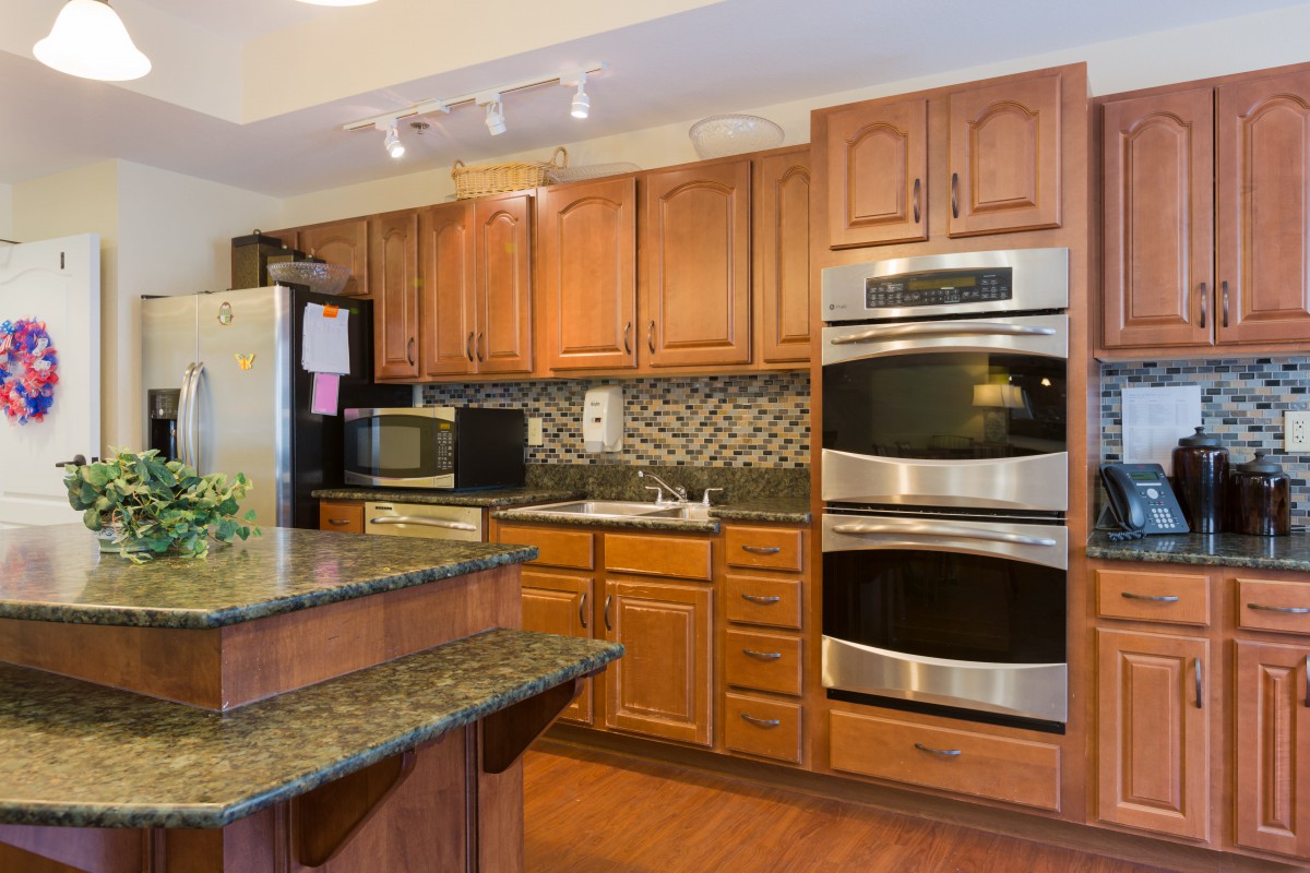 Modern kitchen with wooden cabinets and stainless steel appliances.