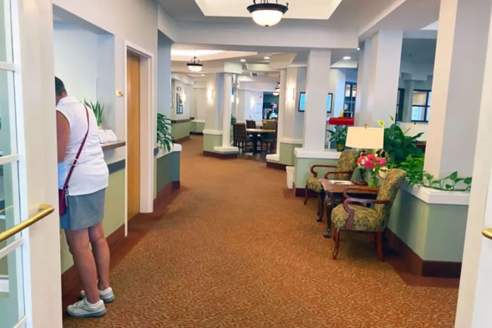 A bright lobby area with comfortable seating and plants.