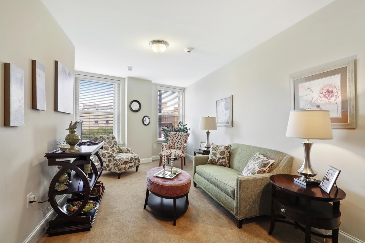 A cozy living room with a sofa, coffee table, and decorative elements.