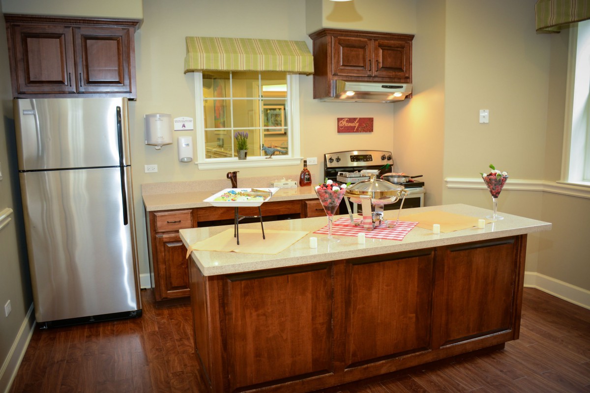 A modern kitchen with wooden cabinets and a central island.