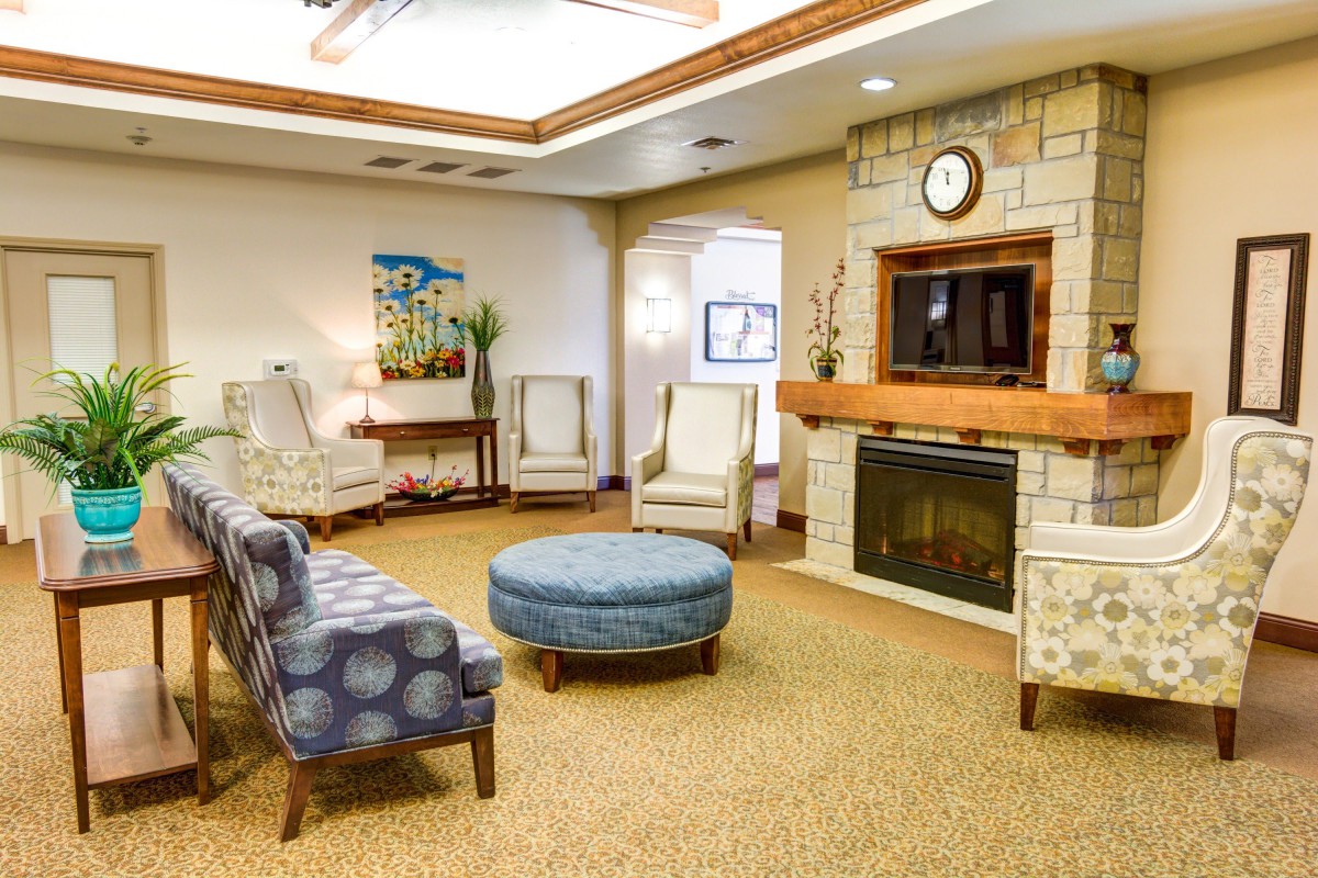 A cozy living room with a fireplace and comfortable seating.