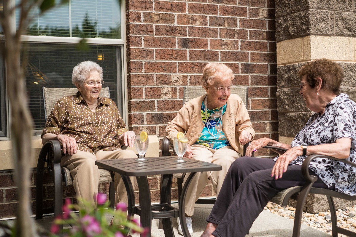 A group of seniors enjoying a conversation outdoors.