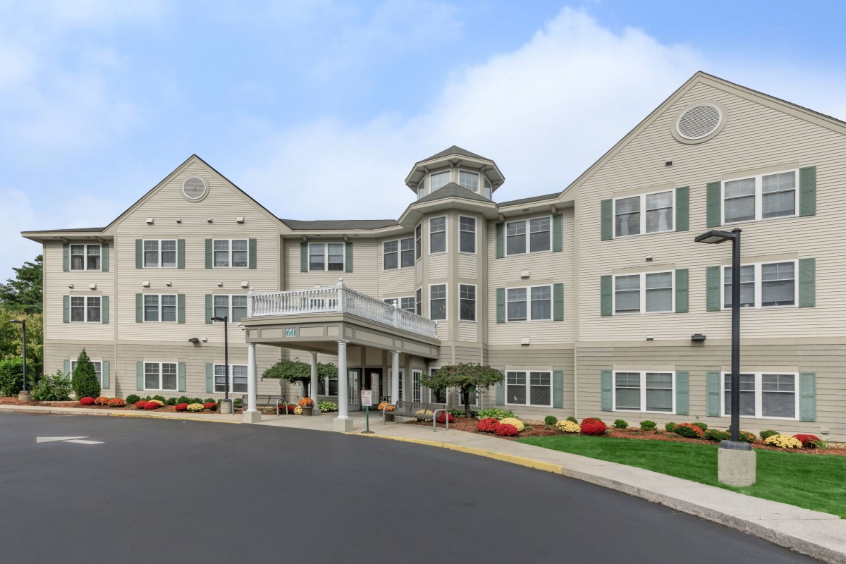 A large residential building with a landscaped exterior, possibly an assisted living or senior care facility.