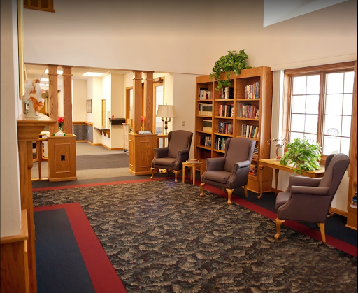 A cozy library interior featuring comfortable seating and bookshelves.