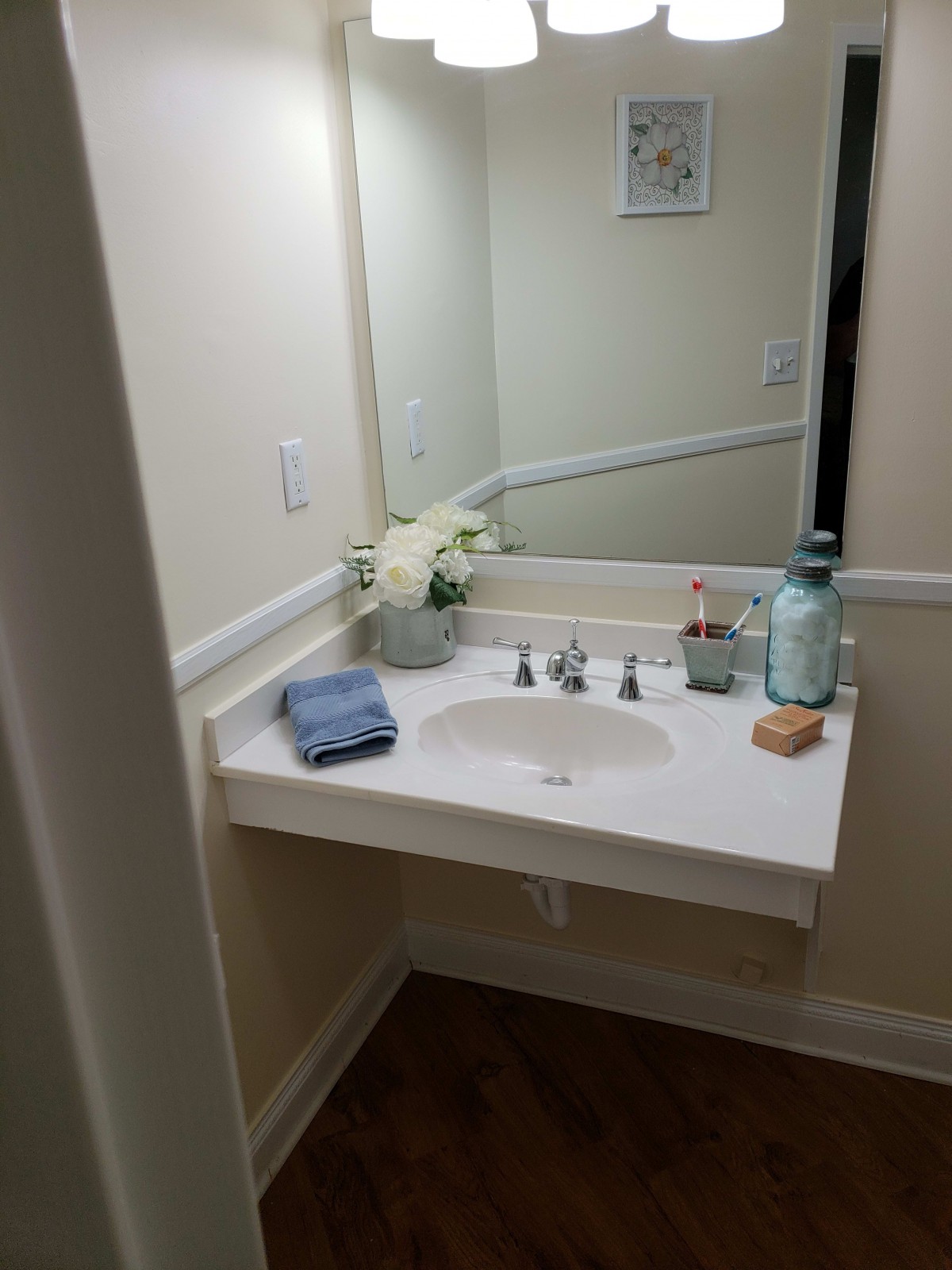 A tidy bathroom sink area with decorative elements.
