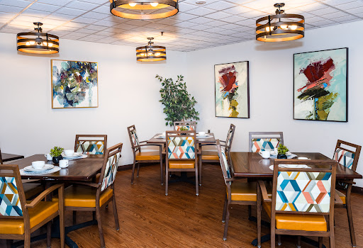 A stylish dining room featuring modern furniture and artistic decor.