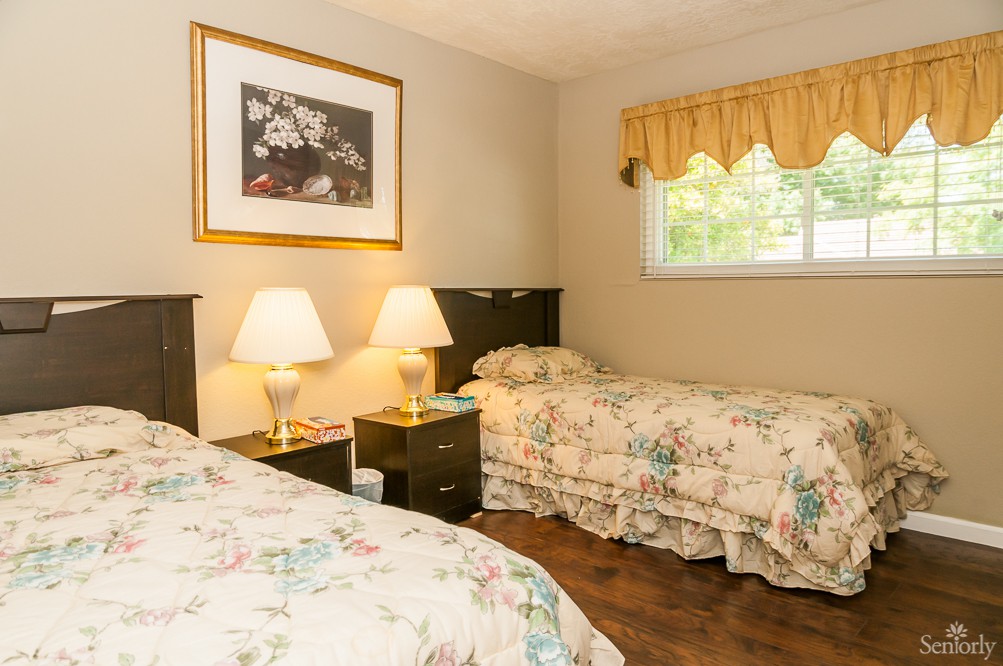 A cozy bedroom with twin beds and floral bedding.