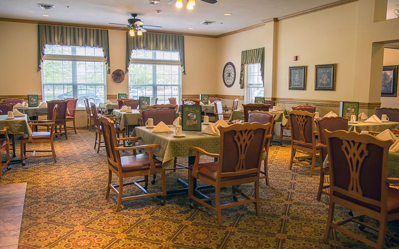 A cozy dining room with neatly arranged tables and chairs, ready for guests.