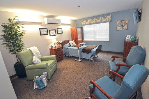 A cozy patient room in a healthcare facility, featuring comfortable seating and well-designed interiors.