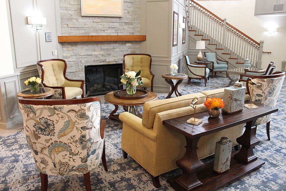 A stylish living room with a fireplace, featuring elegant furniture and tasteful decor.