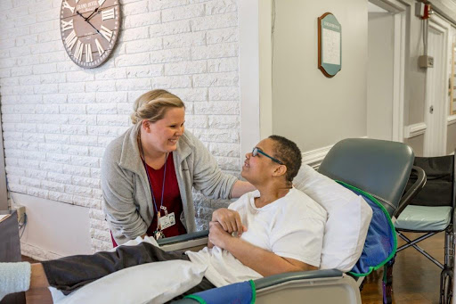 A nurse providing compassionate care to a patient in a medical setting.