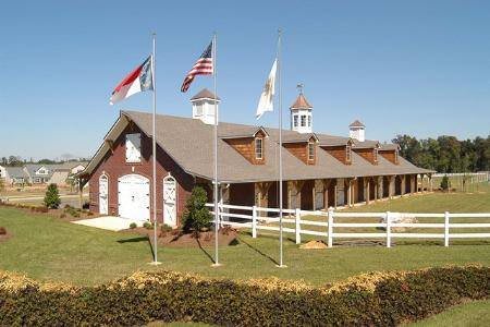 A picturesque barn with flags on a sunny day.