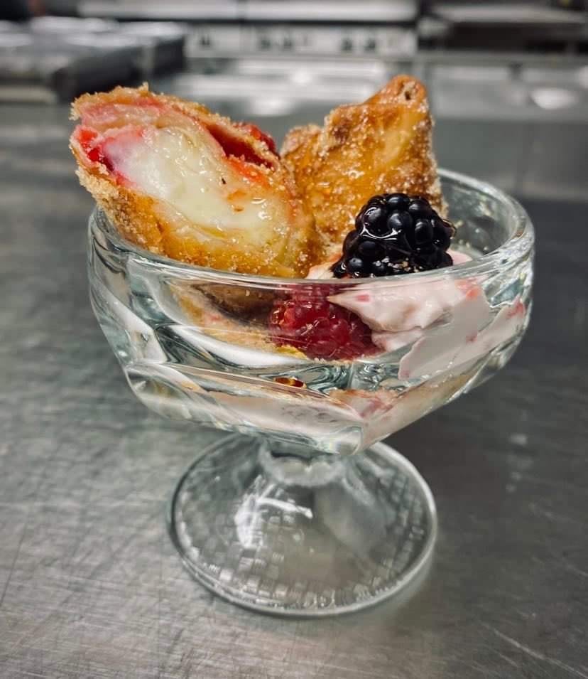 Delicious dessert featuring crispy pastry and fresh berries served in a glass dish.