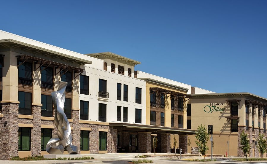A modern building with a prominent outdoor sculpture.