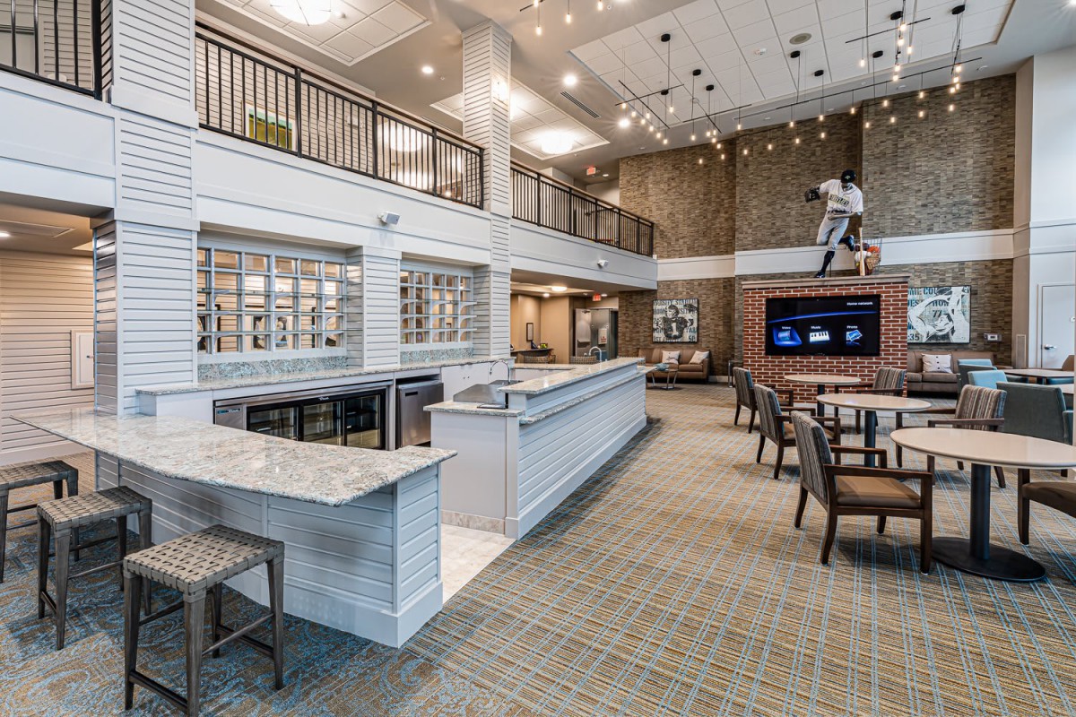 Modern lounge area with high ceilings and a spacious seating arrangement.