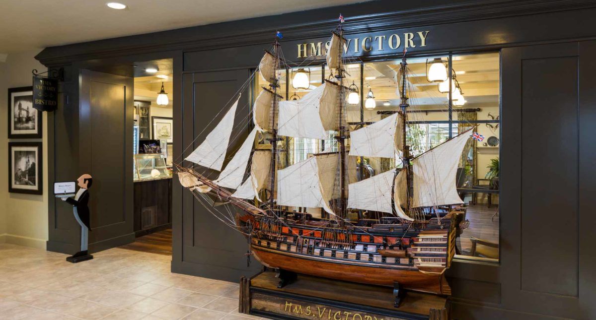 A detailed model of the HMS Victory displayed in a museum setting.