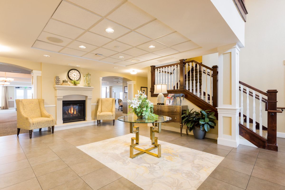 Elegant living room with a fireplace and stairway entrance.