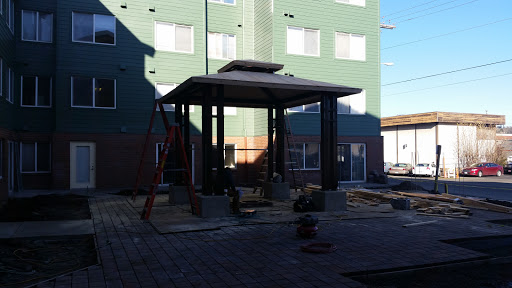 A pavilion under construction in an outdoor area, showcasing modern architectural elements.