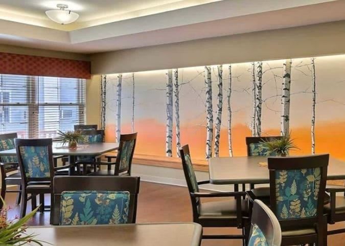 A modern dining area with stylish wall art and comfortable seating.