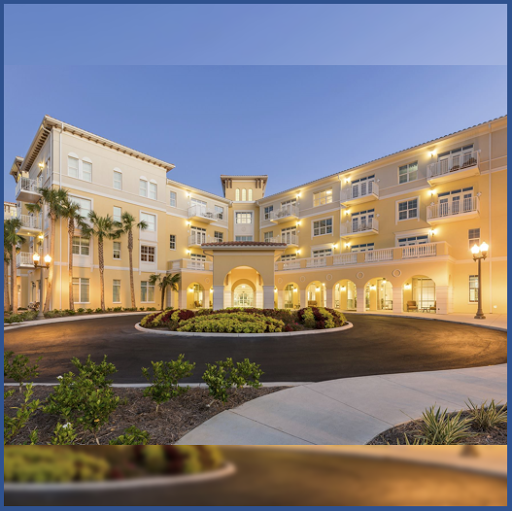 A beautifully lit hotel exterior at dusk, surrounded by lush landscaping.