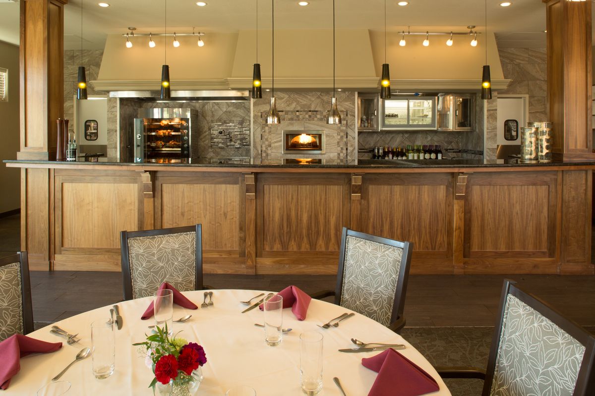 An elegantly set dining table in a restaurant with modern interior design.