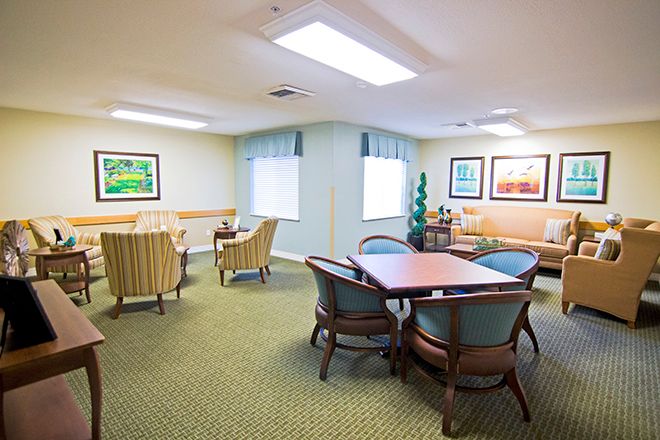A cozy living room area with comfortable seating and decorative artwork on the walls.