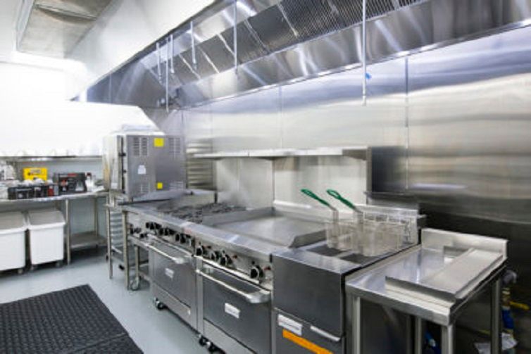 A clean and well-equipped commercial kitchen with stainless steel appliances.
