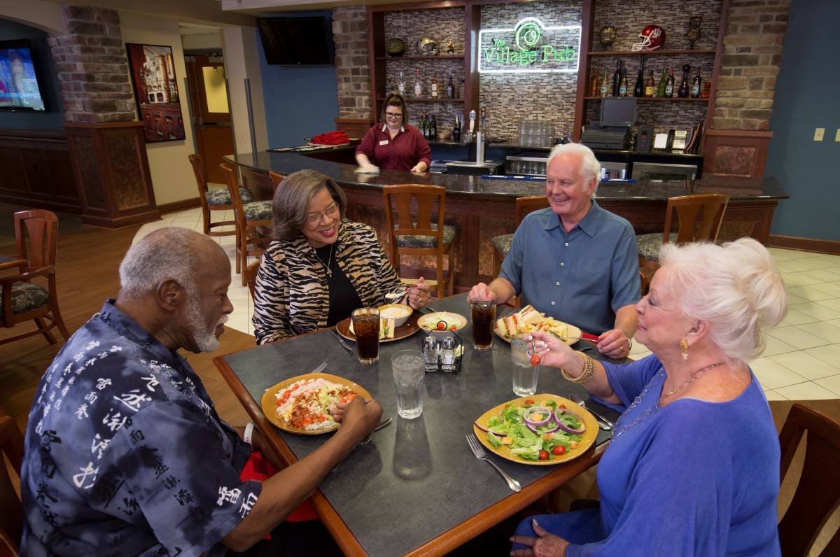 A group of seniors enjoying a meal together at a restaurant.