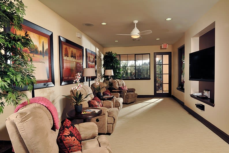 A cozy waiting room with comfortable armchairs and artwork adorning the walls.