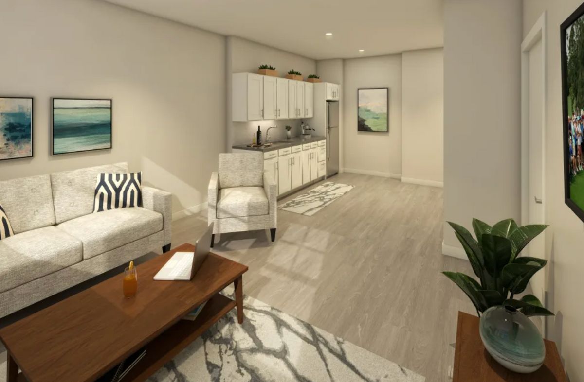 A modern, minimalist living room with an integrated kitchen area, featuring neutral tones and stylish furniture.