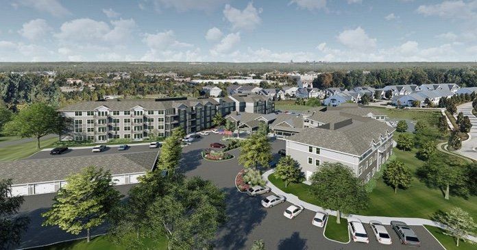 Aerial view of a residential apartment complex surrounded by greenery.