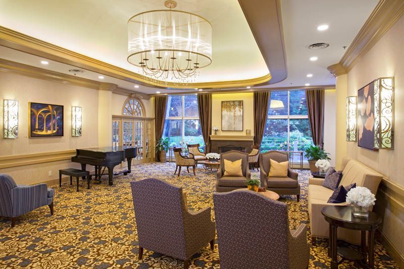 A luxurious lounge with elegant furnishings and a grand piano.
