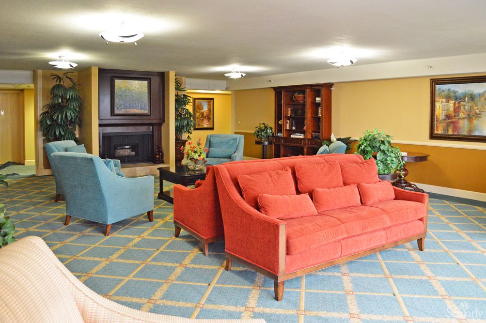 A cozy living room with colorful sofas and elegant interior design.
