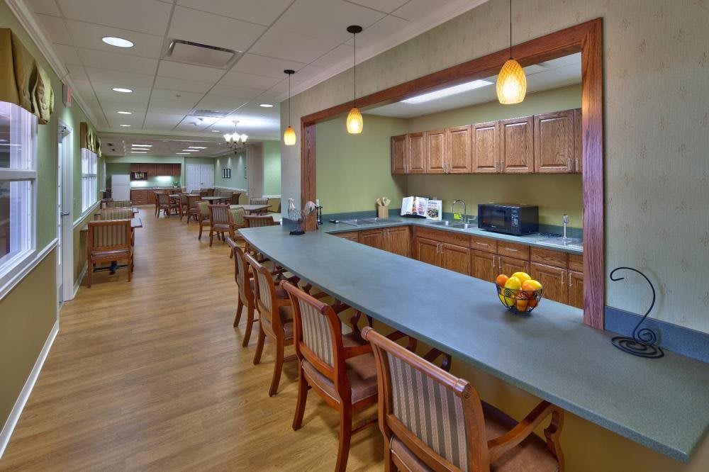 A spacious kitchen and dining area with wooden furniture and modern lighting.