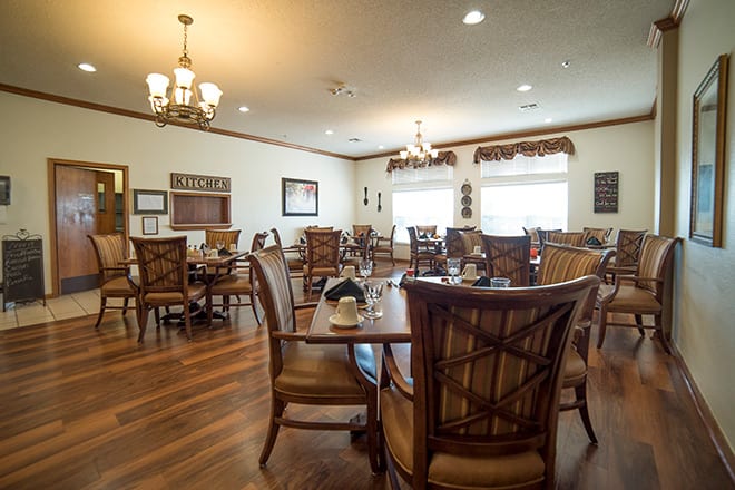 A cozy dining area with wooden furniture and warm lighting.
