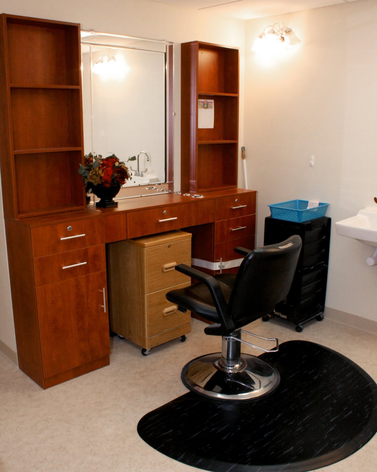 A well-organized hair salon station featuring a styling chair, mirror, and storage cabinets.