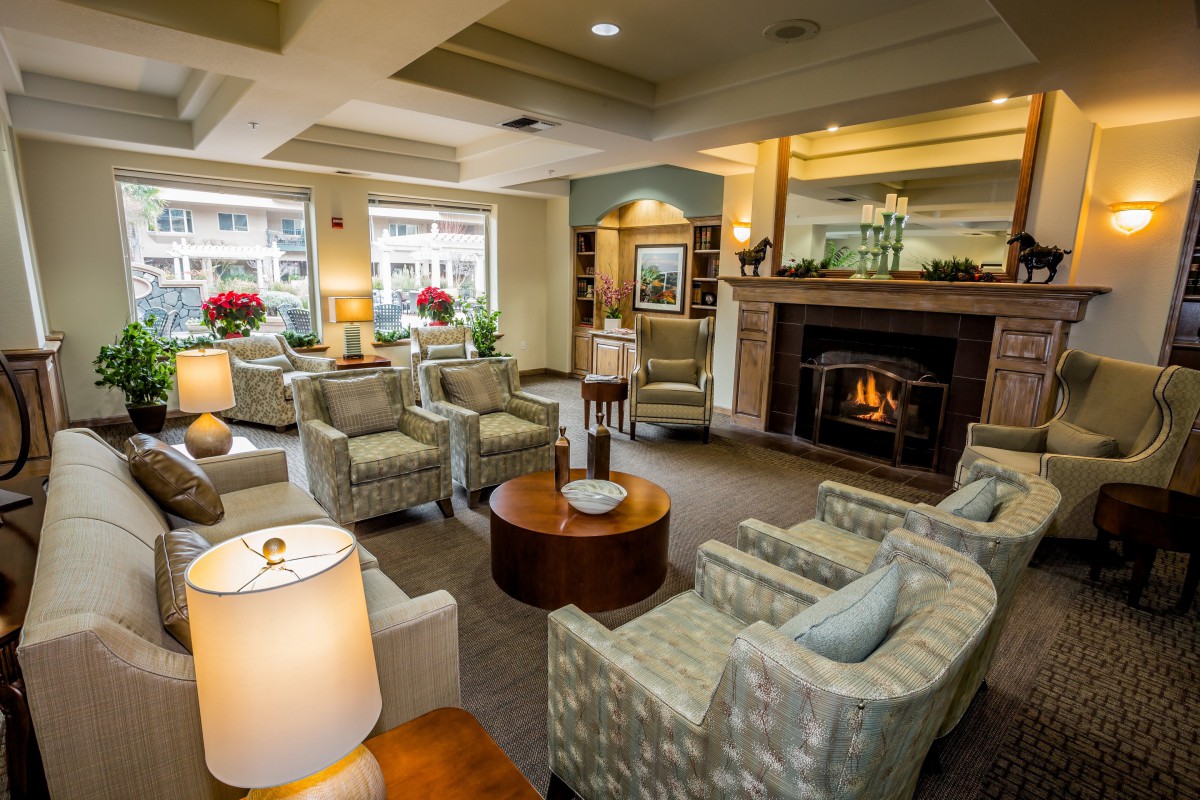 A cozy living room with a warm fireplace and comfortable seating arrangements.