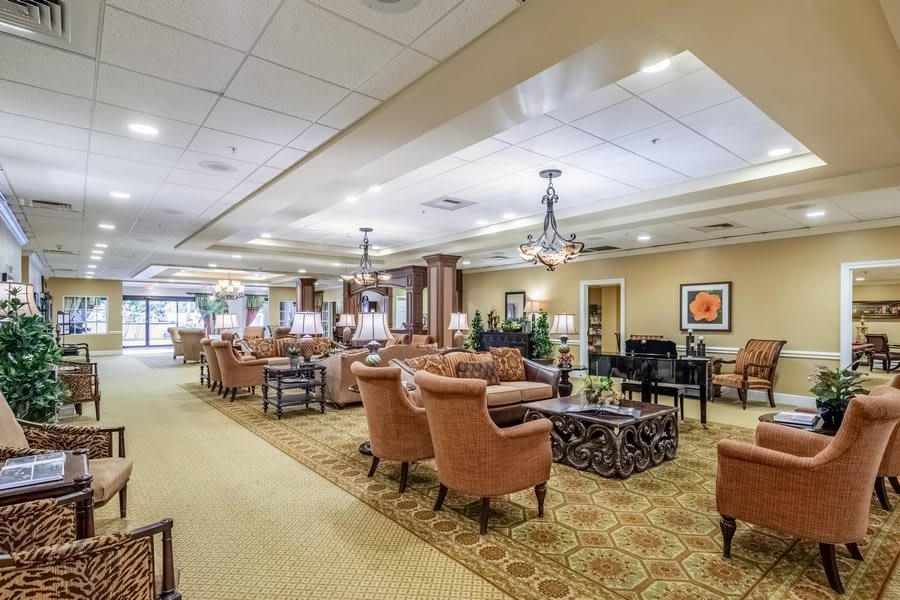A spacious and elegantly decorated lounge area with comfortable seating and warm lighting.
