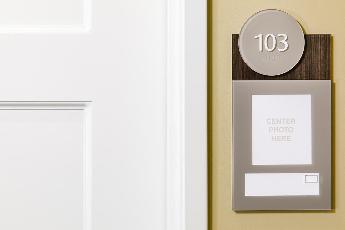A door with the room number 103 displayed on a sign.