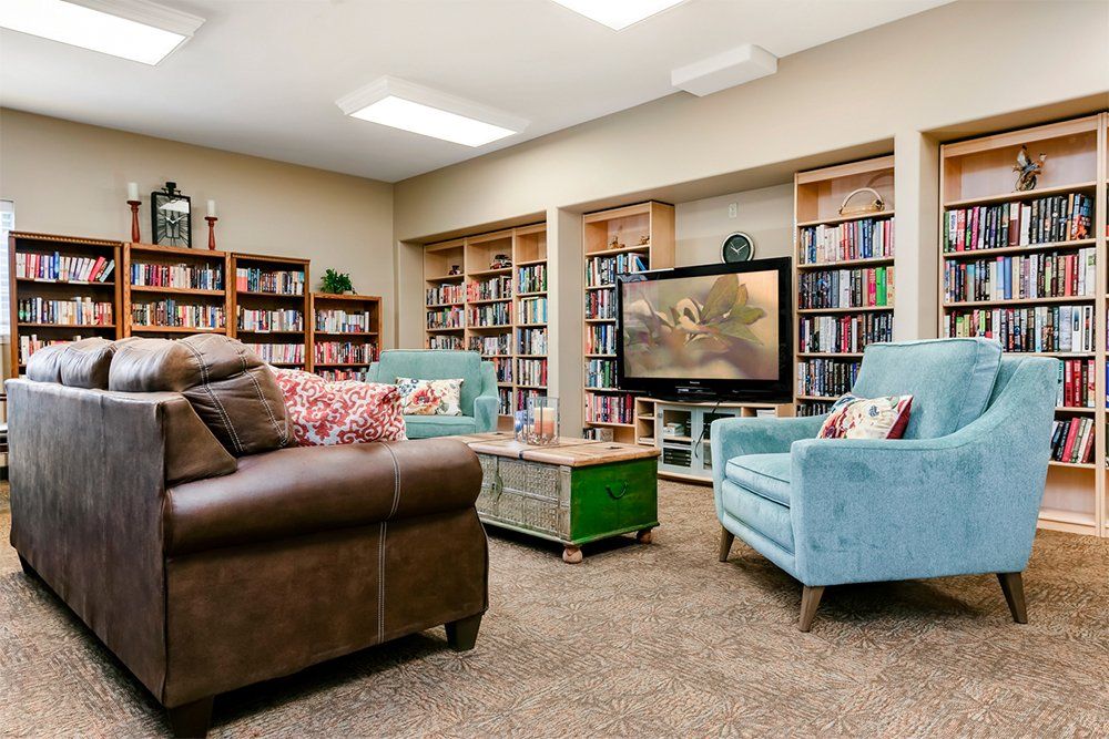 A cozy living room with bookshelves and comfortable seating.